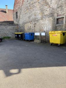 a row of trash cans sitting next to a building at Junges Appartement in Weikersheim +3 photos