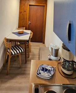 a kitchen with a table and a counter top at Ferienwohnung Glashauser in Biedenkopf