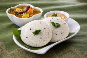 a plate of food with two rolls and a bowl of soup at Bougainvillea in Chikmagalūr