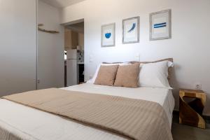 a bedroom with a white bed with two pillows at Villa Theros in Ierapetra