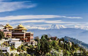 a view of a city with mountains in the background at Mita Hotel - Land of Himalayas in Dhulikhel