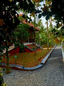 a house with a road in front of it at Mitra retreats in Mānantoddy