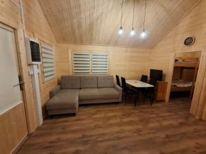 a living room with a couch and a table at Chata Zbója - Sidzina in Sidzina
