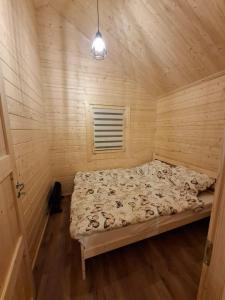 a bedroom with a bed in a wooden room at Chata Zbója - Sidzina in Sidzina
