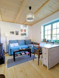 a living room with a blue couch and a table at Mera Small House in Mera