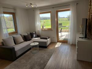 a living room with a couch and a table at Apartment in Stetten bei Mindelheim in Stetten