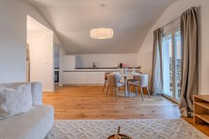 a living room and kitchen with a table and chairs at Vanilla Suite · Kilchberg in Kilchberg +1 photo