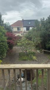 a view of a garden with a house in the background at King Room sheared house in Bristol