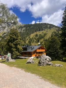 a large wooden house in the middle of a mountain at Casa di Chiara Andalo Centro in Andalo