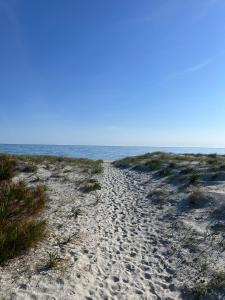 a sandy beach with the ocean in the background at Casa Antonietta in Santa Lucia +4 photos