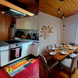 a kitchen with a table and a kitchen with white cabinets at Ferienwohnung Altes Schulhaus Walberngrün in Grafengehaig