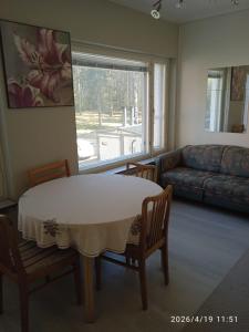 a living room with a table and chairs and a couch at Worker Accomodation in Kouvola