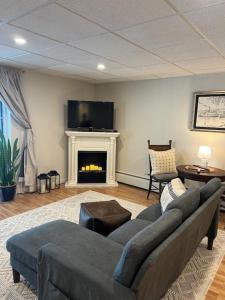 a living room with a couch and a fireplace at Beacon Hudson Hideaway in Beacon