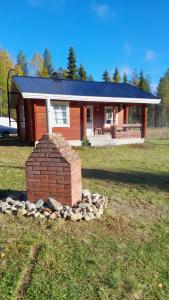 a brick monument in front of a house at Mökki Katjukka, Ruka in Kuusamo