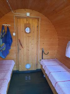 a room with two beds in a wooden cabin at Mökki Katjukka, Ruka in Kuusamo +7 photos