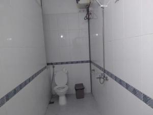 a small bathroom with a toilet and a shower at Gia Cat Long Hotel & Travel in Cat Ba +19 photos