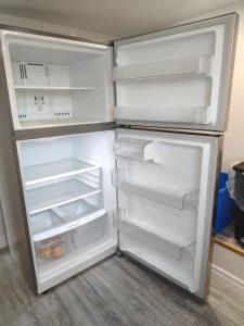 an empty refrigerator with its door open in a kitchen at Bright Ensuite Room with 2 Queen Beds-3A in Halifax +6 photos