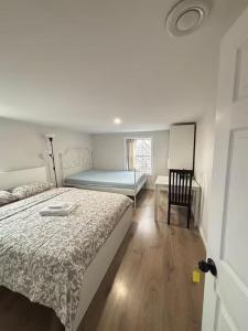 a bedroom with a bed and a table and a chair at Bright Ensuite Room with 2 Queen Beds-3A in Halifax