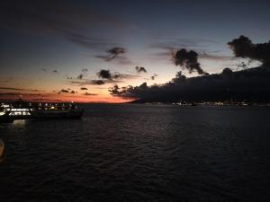 a boat in the water with a sunset at Turi house in Messina