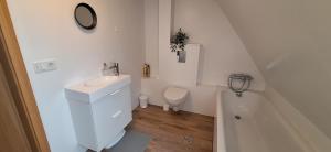 a bathroom with a sink and a toilet and a tub at Cottage in the middle of nowhere in Ölfus +8 photos