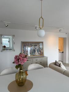 a living room with a vase with flowers on a table at Sea view in Dubrovnik