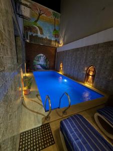 a large swimming pool in a room with a pool at KR Hotel in Luxor