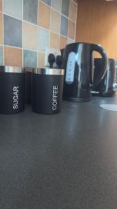 three coffee cups sitting on top of a counter at King Room sheared house in Bristol +12 photos