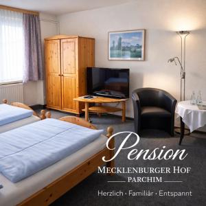 a hotel room with a bed and a desk and a tv at Mecklenburger Hof in Parchim