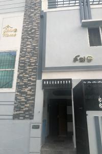 a entrance to a building with a black door at ShivOhome in Tiruvannāmalai +3 photos