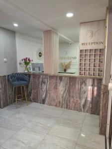 a lobby with a counter and a chair in a room at Valentino Međugorje in Međugorje