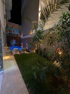 a garden with chairs and a table in a building at KR Hotel in Luxor