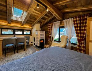 a bedroom with a bed and a dining room at Chalet-Kitzalpen in Hollersbach im Pinzgau