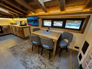 a kitchen and dining room with a wooden table and chairs at Chalet-Kitzalpen in Hollersbach im Pinzgau