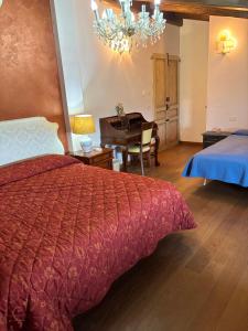 a bedroom with a bed and a desk with a piano at Terra e Mare in Santa Maria Pietrafitta