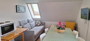 a living room with a couch and a table at Cottage in the middle of nowhere in Ölfus