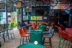 a bar with chairs and tables in a restaurant at Muthiga Garden Resort Chaka in Nyeri
