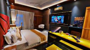 a hotel room with a bed and a television at Victorian Elegance Luxury Stays in Amritsar