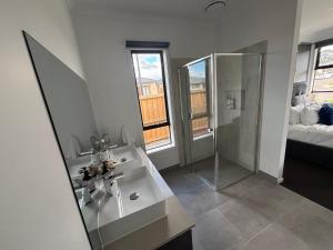 a bathroom with a sink and a glass shower at Urban Pause - Donnybrook in Donnybrook