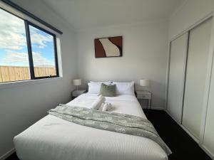 a bedroom with a bed with a teddy bear on it at Urban Pause - Donnybrook in Donnybrook