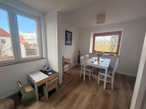 a living room with a table and a dining room at Cozy Home in Schramberg