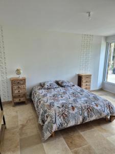 a bedroom with a bed and a dresser and a window at La Cabane du Porteau in Saint-Georges-sur-Cher +22 photos