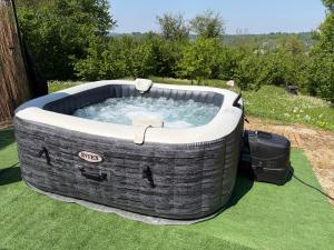 a large jacuzzi tub sitting on the grass at Camera Glicine con bagno privato in Castellero +17 photos