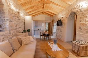 a living room with a couch and a table at Anemolithos Mani's House in Areopoli