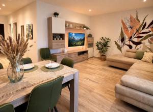 a living room with a dining table and a couch at Casa di Chiara Andalo Centro in Andalo