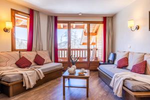 a living room with a couch and a table at Résidence Pierre & Vacances l'Albane in Vars