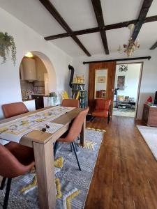 a dining room and kitchen with a table and chairs at Fecskefészek vendégház in Nagymaros +36 photos