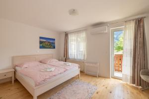 a bedroom with a bed and a large window at Rooms Hrominc in Bled
