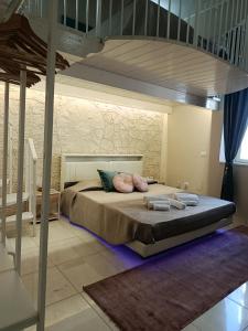 a bedroom with a large bed with pillows on it at Casa vacanze So Suite 24 in Reggio di Calabria