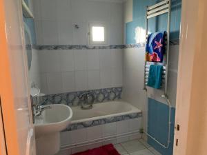 a bathroom with a tub and a sink at honey moon zeinbe 4 in Hammamet +10 photos
