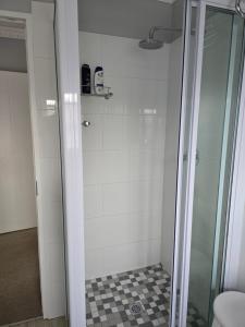 a shower with a glass door in a bathroom at Hope at Mangaliso in Hilton +42 photos